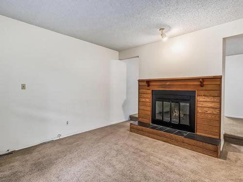 16 7604 29 Avenue, Edmonton, AB - Indoor Photo Showing Living Room With Fireplace