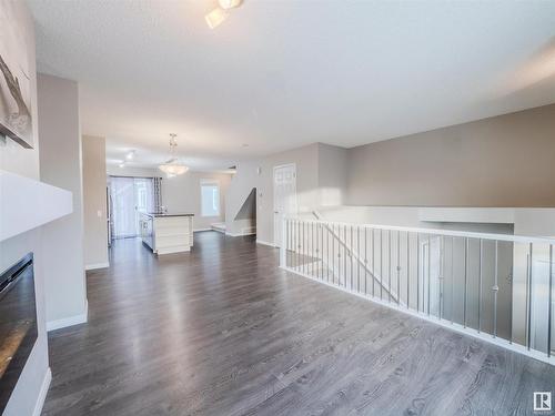 37 4050 Savaryn Drive, Edmonton, AB - Indoor Photo Showing Living Room With Fireplace