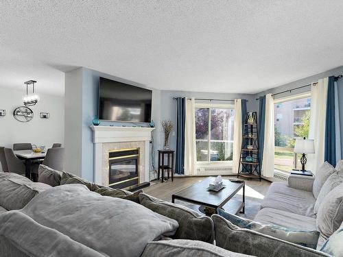 212 15499 Castle Downs Road, Edmonton, AB - Indoor Photo Showing Living Room With Fireplace