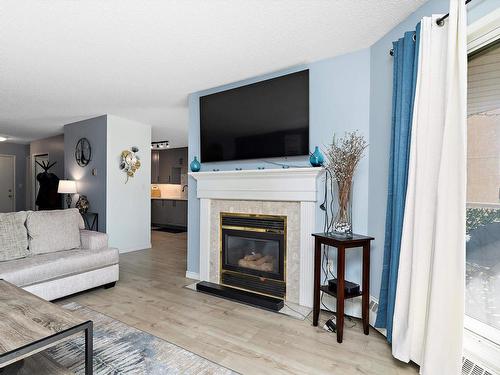 212 15499 Castle Downs Road, Edmonton, AB - Indoor Photo Showing Living Room With Fireplace