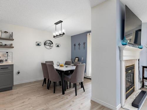 212 15499 Castle Downs Road, Edmonton, AB - Indoor Photo Showing Dining Room With Fireplace