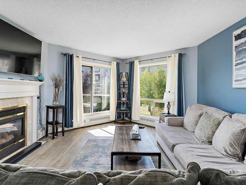 212 15499 Castle Downs Road, Edmonton, AB - Indoor Photo Showing Living Room With Fireplace