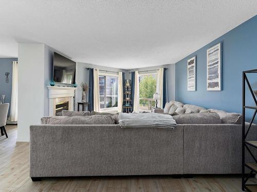 212 15499 Castle Downs Road, Edmonton, AB - Indoor Photo Showing Living Room With Fireplace