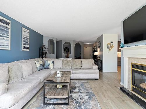 212 15499 Castle Downs Road, Edmonton, AB - Indoor Photo Showing Living Room With Fireplace