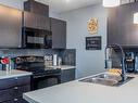 446 1196 Hyndman Road Nw, Edmonton, AB  - Indoor Photo Showing Kitchen With Double Sink 