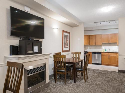 414 2035 Grantham Court, Edmonton, AB - Indoor Photo Showing Dining Room With Fireplace