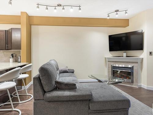 414 2035 Grantham Court, Edmonton, AB - Indoor Photo Showing Living Room With Fireplace