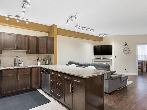 414 2035 Grantham Court, Edmonton, AB - Indoor Photo Showing Kitchen With Fireplace