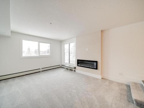 202 9504 182 Street, Edmonton, AB - Indoor Photo Showing Other Room With Fireplace