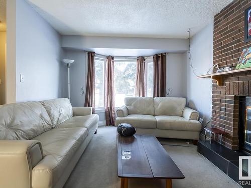 4571 32 Avenue, Edmonton, AB - Indoor Photo Showing Living Room With Fireplace