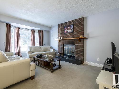 4571 32 Avenue, Edmonton, AB - Indoor Photo Showing Living Room With Fireplace