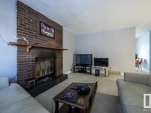 4571 32 Avenue, Edmonton, AB - Indoor Photo Showing Living Room With Fireplace