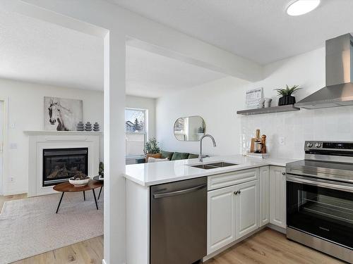 35 230 Edwards Drive, Edmonton, AB - Indoor Photo Showing Kitchen With Fireplace With Double Sink