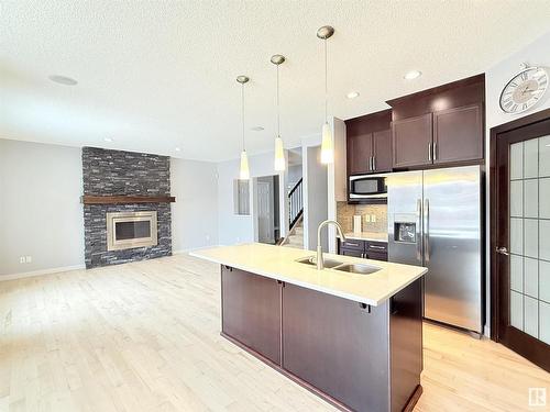 4211 Charles Close, Edmonton, AB - Indoor Photo Showing Kitchen With Fireplace With Stainless Steel Kitchen With Double Sink With Upgraded Kitchen