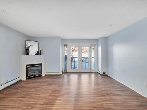 211 10403 98 Avenue, Edmonton, AB - Indoor Photo Showing Living Room With Fireplace