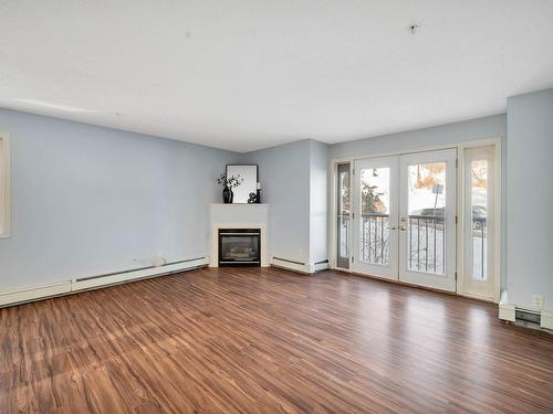 211 10403 98 Avenue, Edmonton, AB - Indoor Photo Showing Living Room With Fireplace