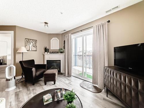 212 16303 95 Street, Edmonton, AB - Indoor Photo Showing Living Room With Fireplace