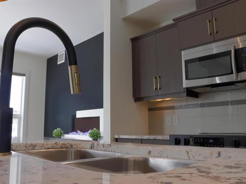 107 10523 123 Street, Edmonton, AB - Indoor Photo Showing Kitchen With Double Sink