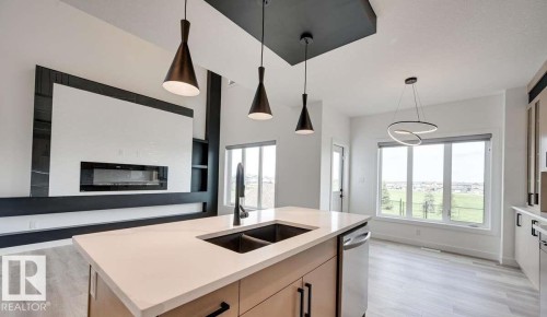 94 Elm Street, Fort Saskatchewan, AB - Indoor Photo Showing Kitchen With Fireplace With Double Sink