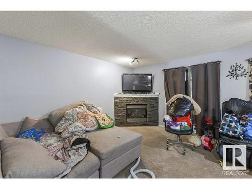 7931 7 Avenue, Edmonton, AB - Indoor Photo Showing Living Room With Fireplace