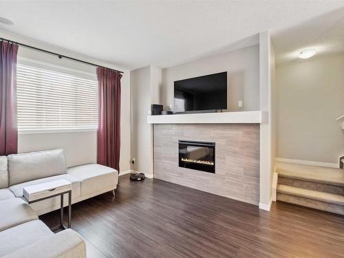 4 320 Secord Boulevard, Edmonton, AB - Indoor Photo Showing Living Room With Fireplace