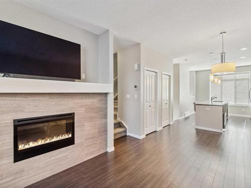 4 320 Secord Boulevard, Edmonton, AB - Indoor Photo Showing Living Room With Fireplace