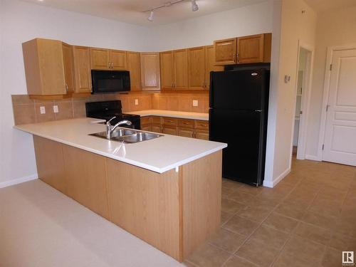 201 160 Magrath Road Nw, Edmonton, AB - Indoor Photo Showing Kitchen With Double Sink