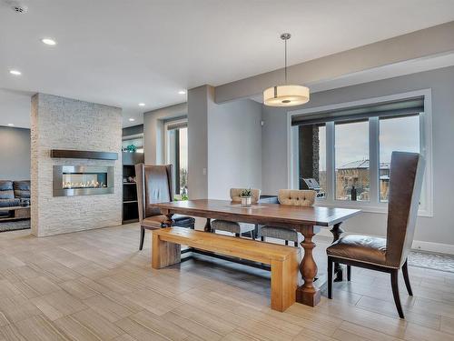 4510 Wingfield Bay, Edmonton, AB - Indoor Photo Showing Dining Room With Fireplace