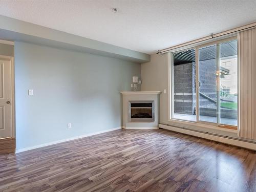 101 17011 67 Avenue, Edmonton, AB - Indoor Photo Showing Living Room With Fireplace