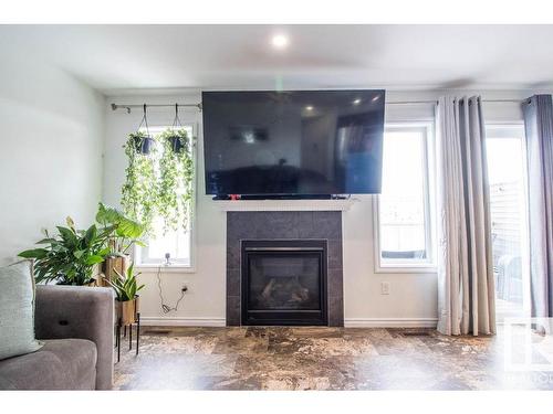 937 Ebbers Crescent Nw, Edmonton, AB - Indoor Photo Showing Living Room With Fireplace