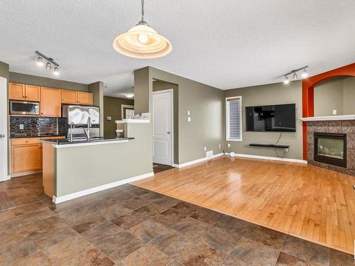 711 89 Street Sw, Edmonton, AB - Indoor Photo Showing Kitchen With Fireplace