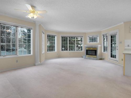 112 17151 94A Avenue, Edmonton, AB - Indoor Photo Showing Other Room With Fireplace