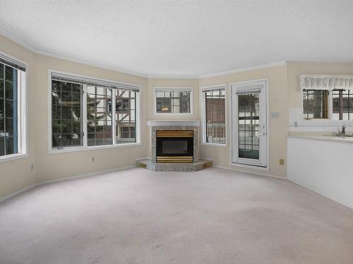 112 17151 94A Avenue, Edmonton, AB - Indoor Photo Showing Living Room With Fireplace