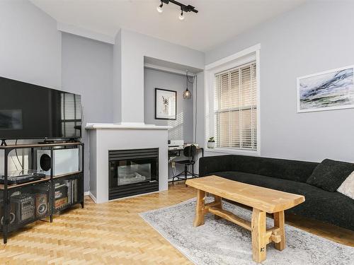 402 10728 82 Avenue, Edmonton, AB - Indoor Photo Showing Living Room With Fireplace