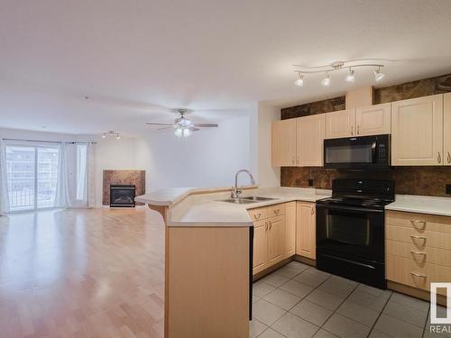 323 4312 139 Avenue, Edmonton, AB - Indoor Photo Showing Kitchen With Fireplace With Double Sink