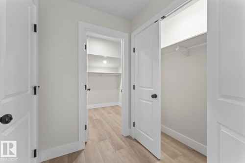 The property features light-colored flooring, white interior doors with dark hardware, and a closet with shelving - 807 Schooner Drive, Cold Lake, AB - Indoor Photo Showing Other Room