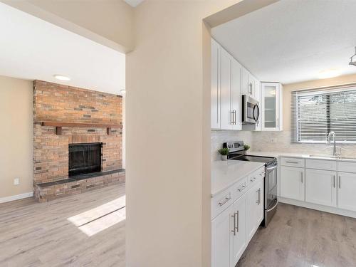 18003 76 Avenue, Edmonton, AB - Indoor Photo Showing Kitchen With Fireplace