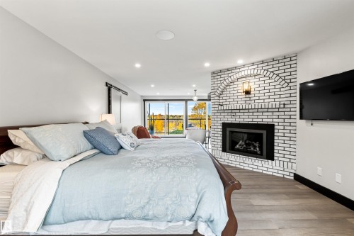 116 Windermere Drive, Edmonton, AB - Indoor Photo Showing Bedroom With Fireplace