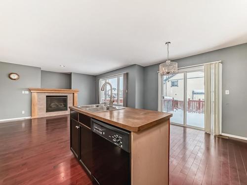 13906 146 Avenue Nw, Edmonton, AB - Indoor Photo Showing Kitchen With Fireplace With Double Sink