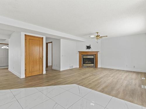 3105 41A Ave, Edmonton, AB - Indoor Photo Showing Living Room With Fireplace