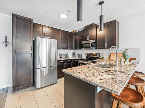 127 5151 Windermere Boulevard, Edmonton, AB - Indoor Photo Showing Kitchen With Stainless Steel Kitchen With Double Sink With Upgraded Kitchen