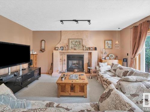 19 Rhatigan Road E, Edmonton, AB - Indoor Photo Showing Living Room With Fireplace