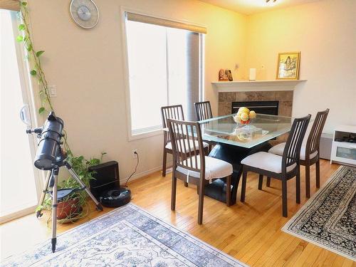 2311 Lemieux Place, Edmonton, AB - Indoor Photo Showing Dining Room With Fireplace