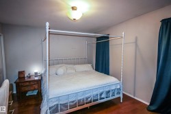 Bedroom with dark wood finished floors and baseboards - 