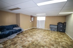 Living area featuring a paneled ceiling and stone finish flooring - 
