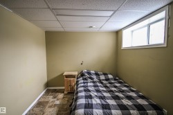 Bedroom with a paneled ceiling and stone finish floors - 