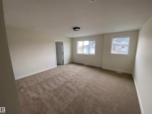 Spare room featuring carpet floors - 5417 60 Avenue, Vegreville, AB - Indoor Photo Showing Other Room