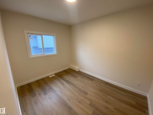 Empty room featuring wood finished floors - 5417 60 Avenue, Vegreville, AB - Indoor Photo Showing Other Room