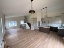 Kitchen with a chandelier, backsplash, modern cabinets, open floor plan, and a kitchen island with sink - 5421 60 Avenue, Vegreville, AB  - Indoor Photo Showing Kitchen 