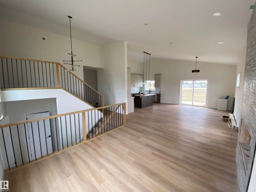 Unfurnished living room with light wood-type flooring, high vaulted ceiling, recessed lighting, and a chandelier - 5421 60 Avenue, Vegreville, AB - Indoor Photo Showing Other Room